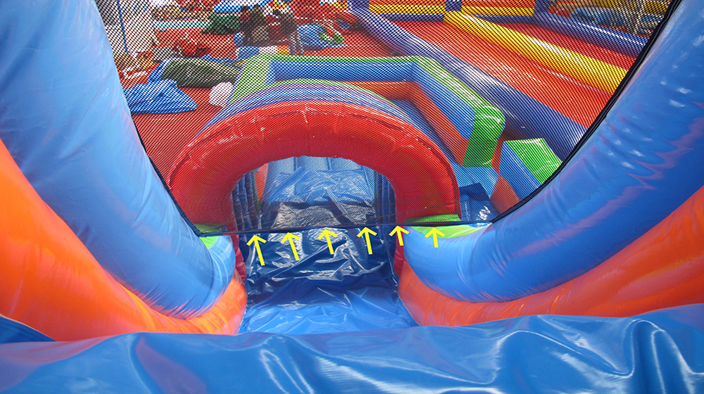 The inflatable water slide has a safety net at the top.